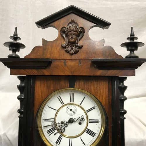 667 - A walnut veneered pendulum wall clock with enamel face and Roman numerals. Case measures approx. 122... 