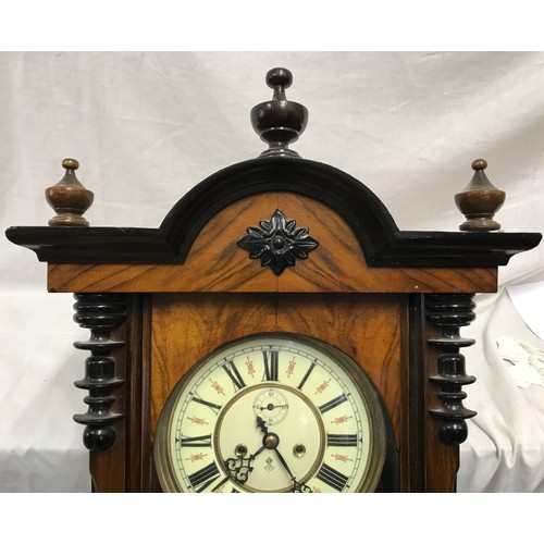 668 - A walnut cased pendulum wall clock with enamel face and Roman numerals, brass weights and winding ha... 