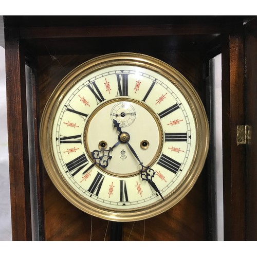 668 - A walnut cased pendulum wall clock with enamel face and Roman numerals, brass weights and winding ha... 