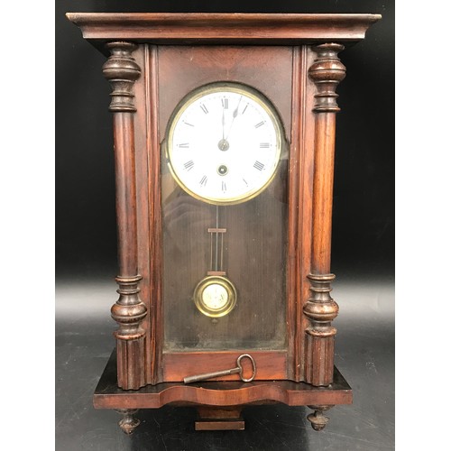 669 - A small walnut veneered cased wall clock 43cms h x 25cms w.