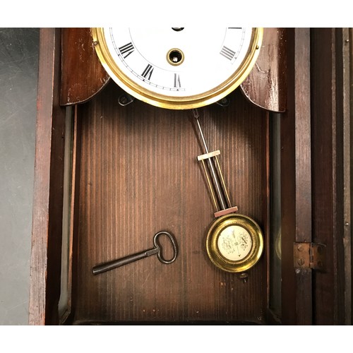 669 - A small walnut veneered cased wall clock 43cms h x 25cms w.