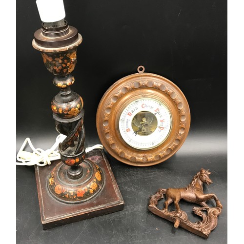 678 - A carved oak circular wall barometer 21cms w, a painted wood table lamp with open twist stem 38cms h... 