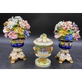 Three pieces of Bloor Derby porcelain to include a pair of floral urns 18cms together with a lidded ... 
