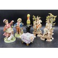 A selection of Continental ceramics to include two pairs of figurines one of ladies with cherubs 22c... 