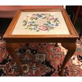 Small oak side table with inlet wool work panel under glass top. 44 w x 50cms h.