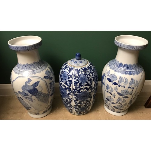 1267 - Pair of Chinese blue and white vases, 47cms h and a blue and white vase with lid 38cms h.