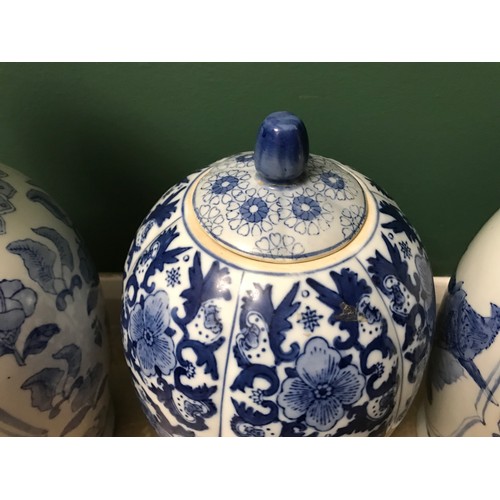 1267 - Pair of Chinese blue and white vases, 47cms h and a blue and white vase with lid 38cms h.