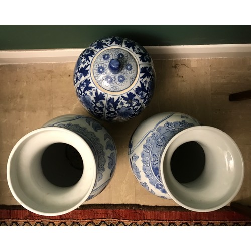 1267 - Pair of Chinese blue and white vases, 47cms h and a blue and white vase with lid 38cms h.