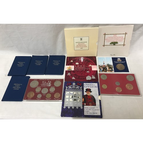 611 - A collection of coins to include 1986, 1987, 1993 and 1994 United Kingdom brilliant uncirculated coi... 