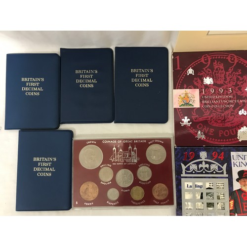 611 - A collection of coins to include 1986, 1987, 1993 and 1994 United Kingdom brilliant uncirculated coi... 