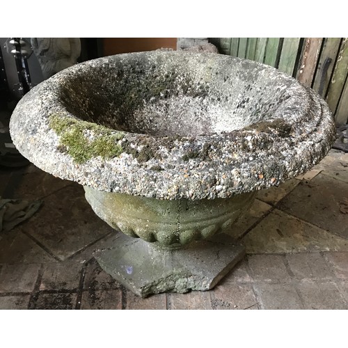 1323 - A reconstituted concrete garden urn on a circular pedestal on a square base approx. 64cms w x 50cms ... 