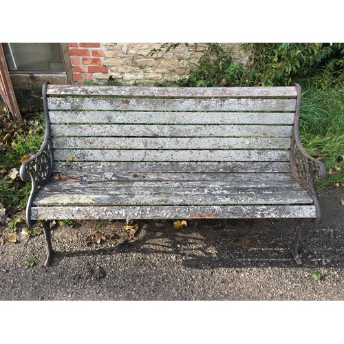 1326 - A cast iron garden bench with lion head design panels, 148cms w x 60cms d x 85cms h.