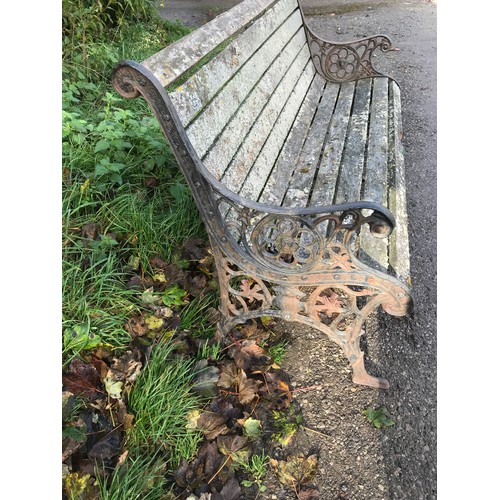 1326 - A cast iron garden bench with lion head design panels, 148cms w x 60cms d x 85cms h.