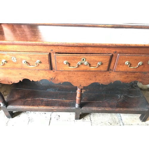 1234 - An 18thC oak welsh dresser with 3 drawer base with brass handles, under shelf and open back top shel... 