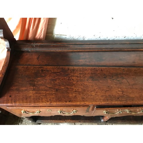 1234 - An 18thC oak welsh dresser with 3 drawer base with brass handles, under shelf and open back top shel... 