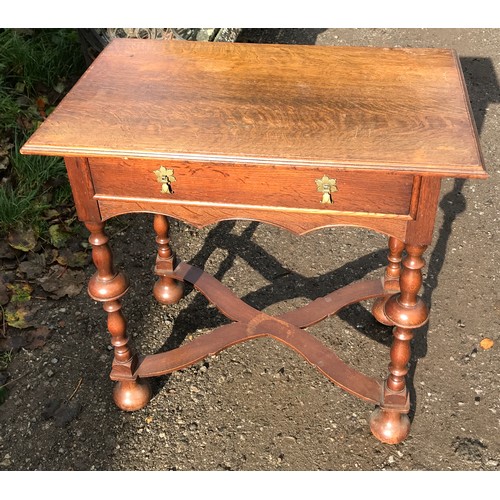 1235 - An oak lowboy with single draw, turned legs and cross stretcher. 71cms w x 45cms d x 70cms h.