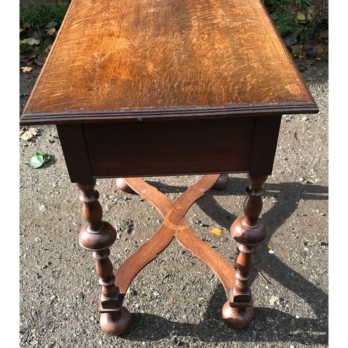 1235 - An oak lowboy with single draw, turned legs and cross stretcher. 71cms w x 45cms d x 70cms h.