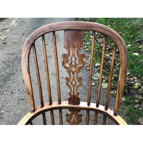 1236 - An oak stick back Windsor armchair. Ht to seat 45cms, ht to back 109cms, width 60cms.