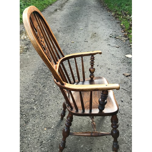 1236 - An oak stick back Windsor armchair. Ht to seat 45cms, ht to back 109cms, width 60cms.