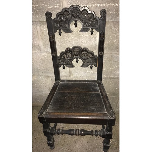 1243 - An 18thC dark oak hall chair carved back stretcher, height to seat 46cms, height to back 105cms, 50c... 