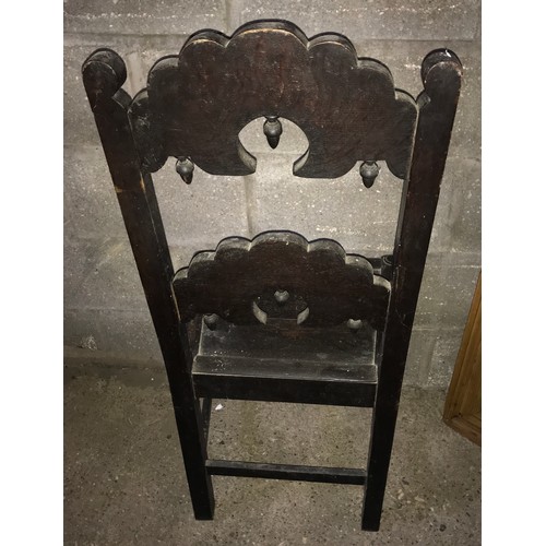 1243 - An 18thC dark oak hall chair carved back stretcher, height to seat 46cms, height to back 105cms, 50c... 