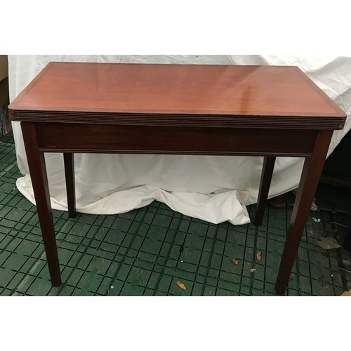 1277 - A mahogany fold-over card table with squared tapered legs. Measures 91cms l x 45cms w x 72cms h.