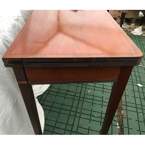 1277 - A mahogany fold-over card table with squared tapered legs. Measures 91cms l x 45cms w x 72cms h.