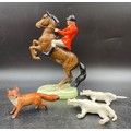 A Beswick figure of a huntsman on a rearing horse 25cms h together with a Beswick fox 6cms h and 2 h... 