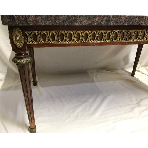 1283 - A granite topped side table with decorative brass to sides and Corinthian column legs. 90cms w x 50c... 