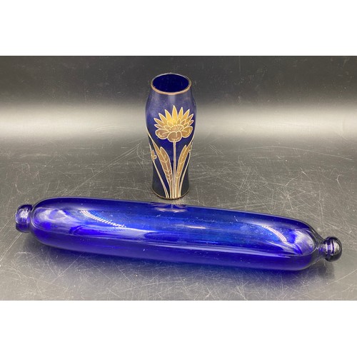 164 - A 19thC Bristol blue glass rolling pin 37cms l together with a blue and gilt vase 16cms h.