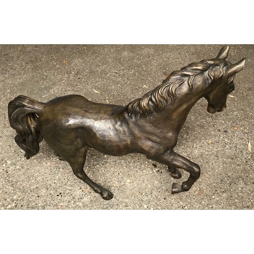 1321 - Large bronze effect figurine of a prancing horse. 69 h x 80cms l.