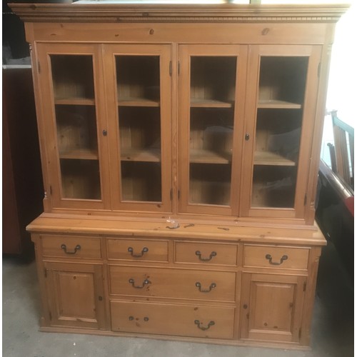 1303 - A large pine wall unit with glazed door top, sideboard base, six drawer, two cupboard. 180cms W x 49... 