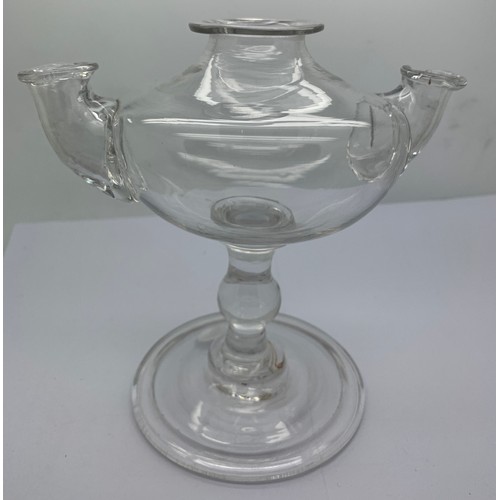 544 - A rare double spout baluster oil lamp. The oval body with a top filling turned neck and spout either... 