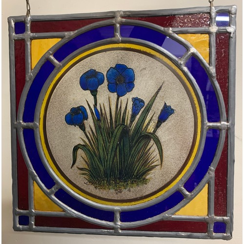 151 - A pair of well made leaded glass window panels, both with centre panels of flowers in multi colours.... 