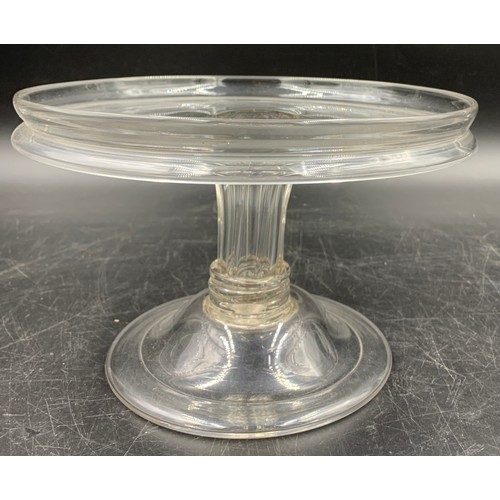 155 - A Georgian glass tazza with a circular galleried top, a generously moulded and collared stem and a d... 