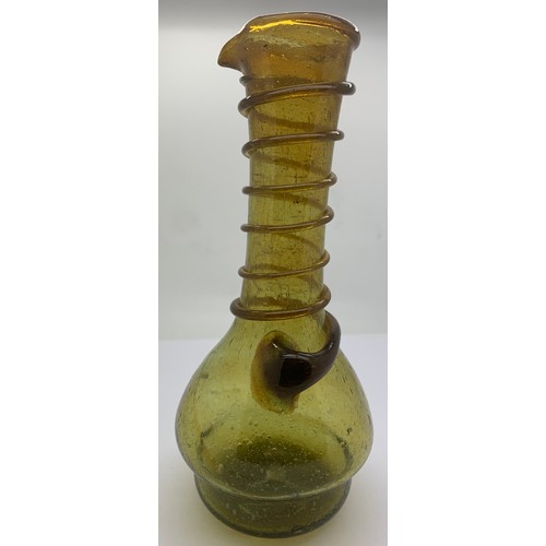 156 - An olive green long neck glass jug with a spiral of green glass rising up the neck to the pourer spo... 