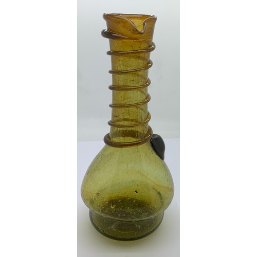 156 - An olive green long neck glass jug with a spiral of green glass rising up the neck to the pourer spo... 