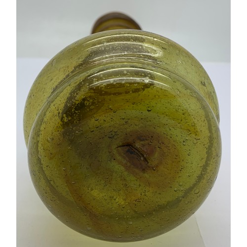 156 - An olive green long neck glass jug with a spiral of green glass rising up the neck to the pourer spo... 