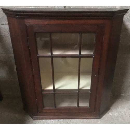 1311 - A mahogany wall mounted display cabinet with panel glass single door. 78cm w x 32cmd x 82cm h.