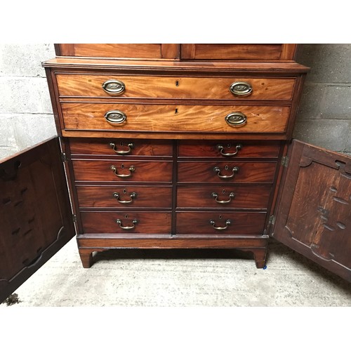 1292 - A Regency mahogany tall cabinet on chest, two door base with fitted drawers interior shelved top. 24... 