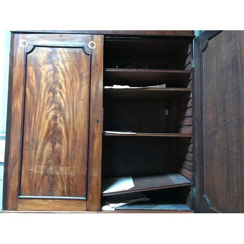 1292 - A Regency mahogany tall cabinet on chest, two door base with fitted drawers interior shelved top. 24... 