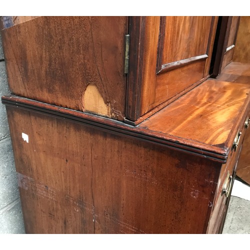 1292 - A Regency mahogany tall cabinet on chest, two door base with fitted drawers interior shelved top. 24... 