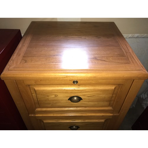 1293 - A light oak four drawer filing cabinet with brass cup handles. 62cms w x 58cms d x130cms h.