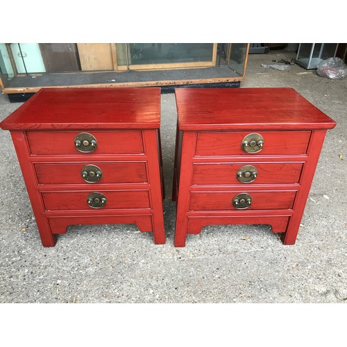 1295 - A pair of Chinese bedside cabinets with three drawers. 52cms w x 39cms d x 61cms h.