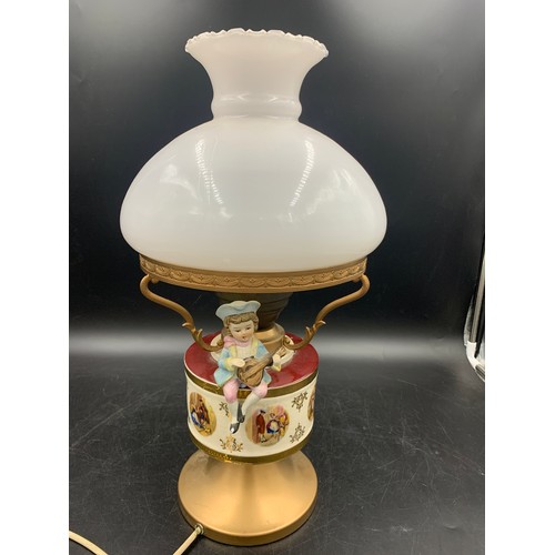 543 - A vintage ceramic and glass table lamp with bisque figure.