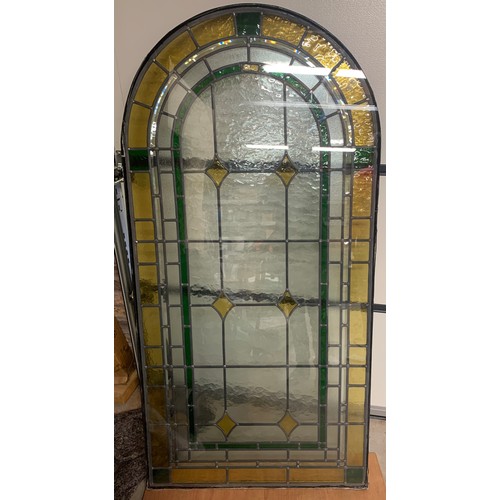 147 - A leaded stained glass arched top window panel. 169 x 84cm.