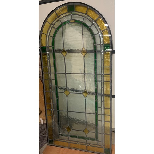 147 - A leaded stained glass arched top window panel. 169 x 84cm.