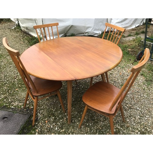 1318 - An Ercol oval drop leaf table with blue label. 113cm x 125cm open, 72cm h together with 4 stick back... 