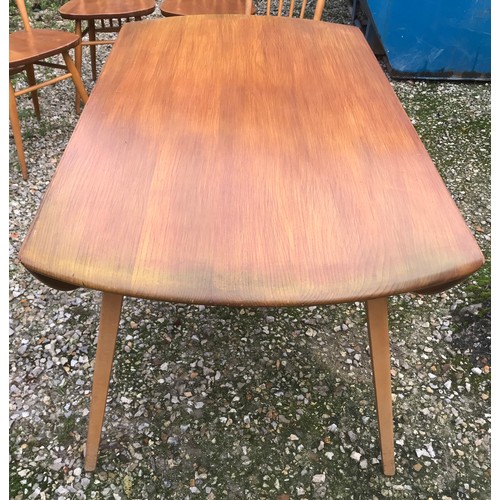 1318 - An Ercol oval drop leaf table with blue label. 113cm x 125cm open, 72cm h together with 4 stick back... 