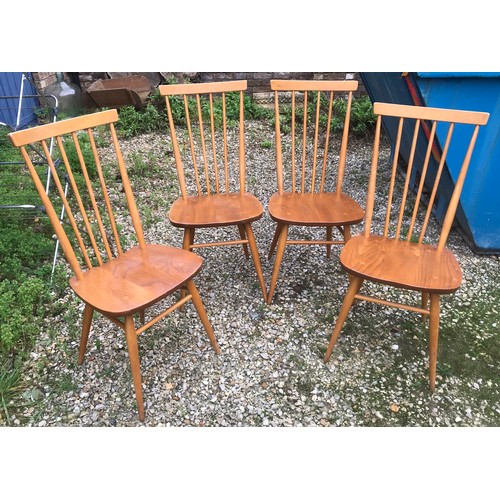 1318 - An Ercol oval drop leaf table with blue label. 113cm x 125cm open, 72cm h together with 4 stick back... 